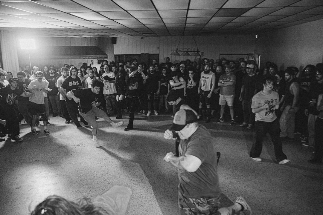 a-black-and-white-photo-of-a-group-of-people-in-a-room-csnyapavvpo